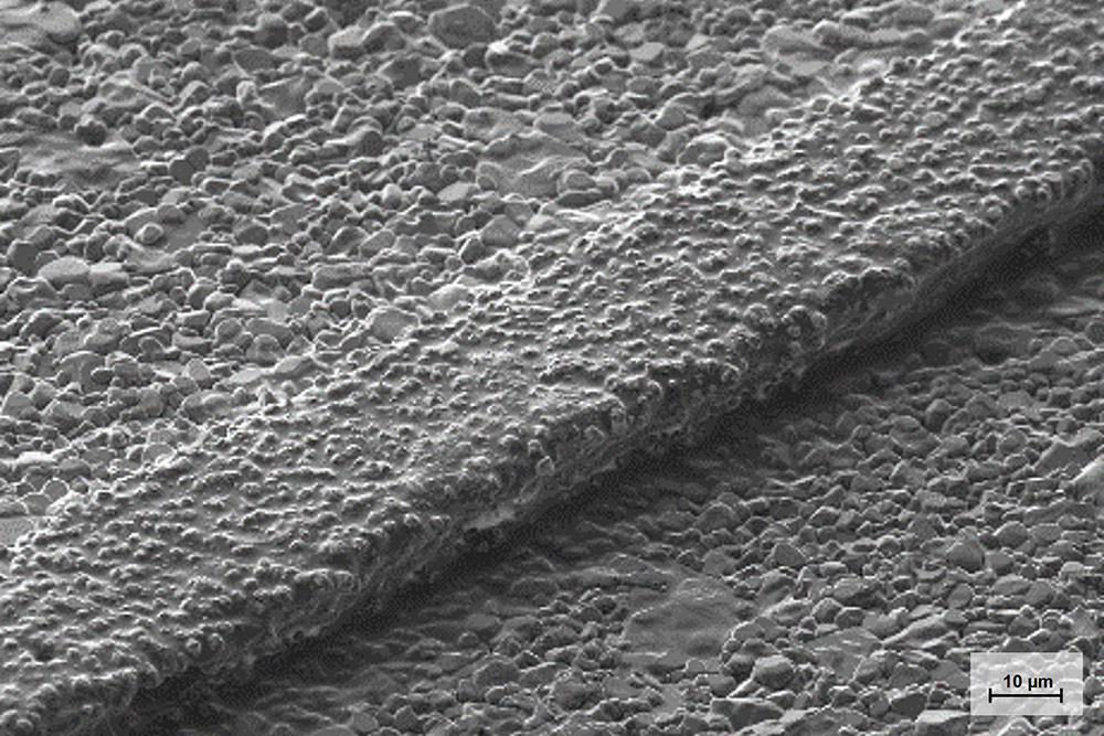 REM-Aufnahme einer ungesinterten Leiterzugflanke (20 µm) auf photostrukturiertem LTCC-Substrat.
