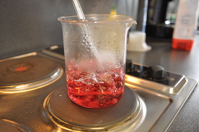 Am Beispiel von Zuckersirup wird die Verarbeitung von Glas demonstriert. Erster Schritt: Erwärmen des Sirups.