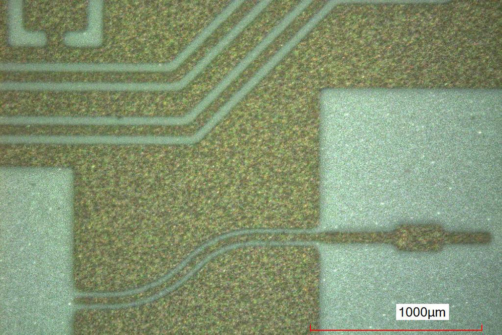 Screen-printed coplanar lines (inner conductor 40 µm) and antenna feed line on LTCC substrate.